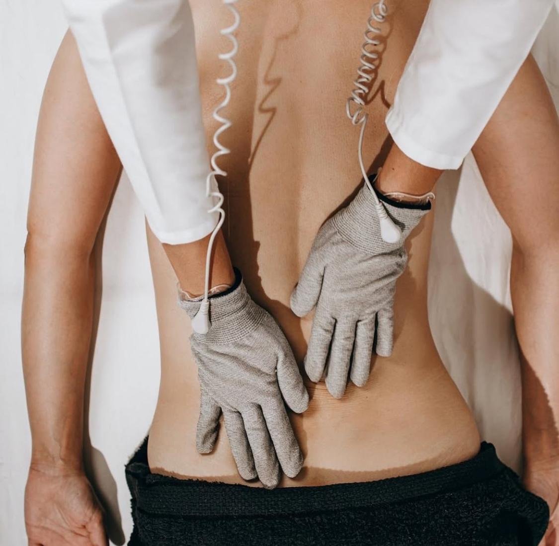 Bioenergetic Meridian Treatment in action - gloves working on client back